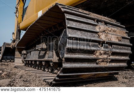 Excavator With Shovel Digs The Ground For The Foundation At Constuction Area.