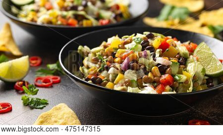 Mexican Style Salad Of Black Beans, Lentils, Corn, Tomato And Lettuce With A Salsa And Tortilla Chip