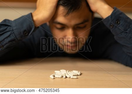 Asian Man Use Pills Overdose, Stressed, Sad, Drug Abuser, Drug Addict, Sick, Unhealthy, Unhappy, Sui