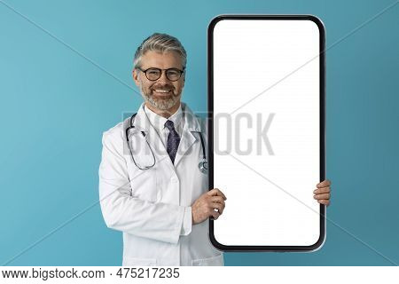 Cheerful Doctor Middle Aged Man Showing Big Phone, Mockup