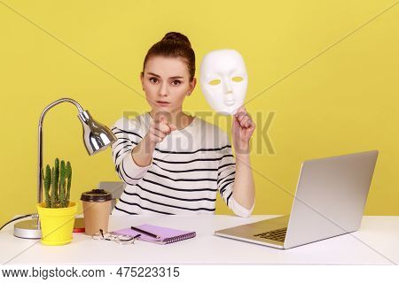 Serious Woman Office Worker Holding White Face Mask And Pointing Finger At Camera, Blaming You For H