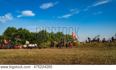 Gniew, Poland, Aug 2020 Polish Hors Cavalry, Hussars, Riding On A Battlefield With Pendants And Flag