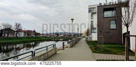 View Of The Road Bridge Over The Morava River In Uherske Hradisti, Residential Buildings In The Back