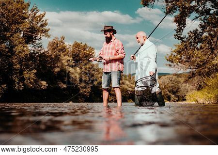 Elegant Bearded Man And Brutal Hipster Fishing. Hobby Sport Activity. Master Baiter. Father And Adul