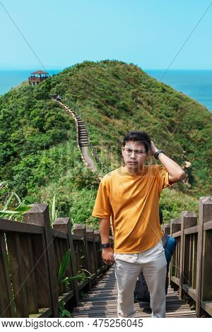 Man Traveler Visiting In Taiwan, Tourist Sightseeing In Bitou Cape Hiking Trail, New Taipei City. La