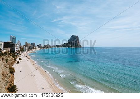 View To Mediterranean Sea With White Sand Beach, Famous Rock Penon De Ifach In Calp, Alicante Provin