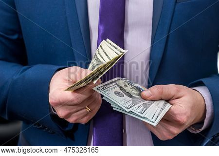 Businessman Holding Large Amount Of Dollar And Give You