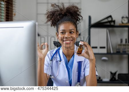 American Female Doctor Is Video Chatting With A Patient, She Is A General Practitioner And Internal