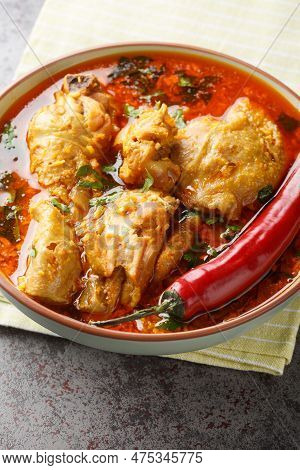 Spicy Indian Malvani Chicken Curry Closeup On The Bowl On The Table. Vertical