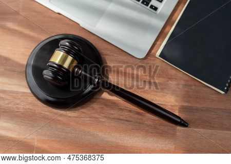 Closeup Top View Black Wooden Gavel Hammer With Laptop On Wooden Office Desk Or Table Background As 