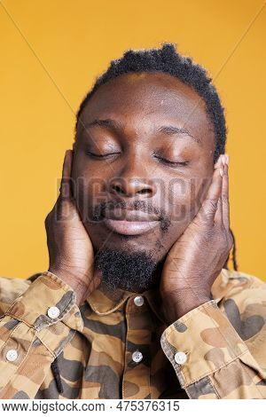 African American Man Covering Ears With Palms, Doing Three Wise Monkeys Gesture In Front Of Camera O