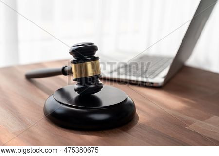 Closeup Wooden Gavel Hammer With Laptop And Book And Pen On Desk On Wooden Office Table Background A