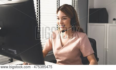 Competent Female Operator Working On Computer And While Talking With Clients. Concept Relevant To Bo