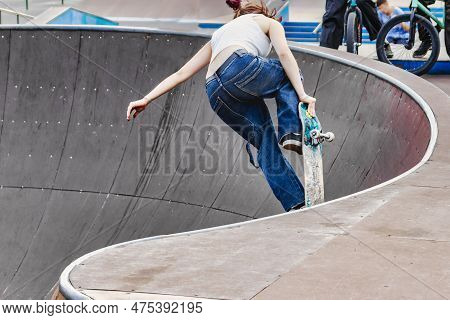 The Girl On The Skateboard Does Incredible Tricks. Sport. Subculture - Youth Passion For Sports. Tri