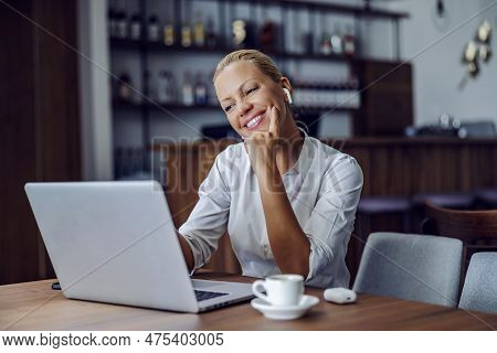 Happy Businesswoman Sitting In The Working Friendly Cafe And Having A Video Call With Colleagues. Re