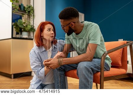 Young Interracial Married Couple Having Intimate Talk At Home, Discussing Marital Problems, Loving C