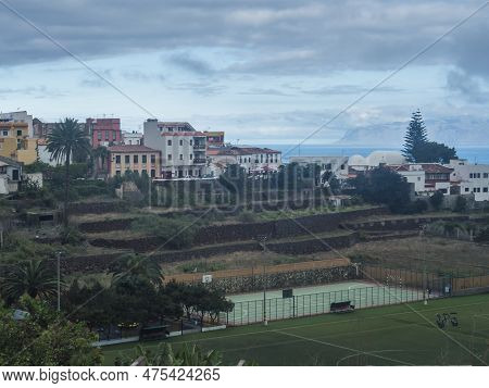 View Of Old Village Agulo With Colorful Traditional Houses, Terraced Fields, Green Field And Mountai