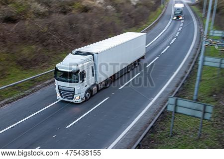 Road Transport. White Lorry Travelling On The Motorway.