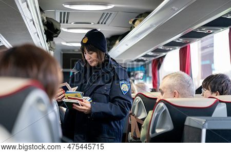 Zagreb, Croatia - December 29, 2019: Police Officer Is Cheking Travellers Pasportsi In The Bus On Th