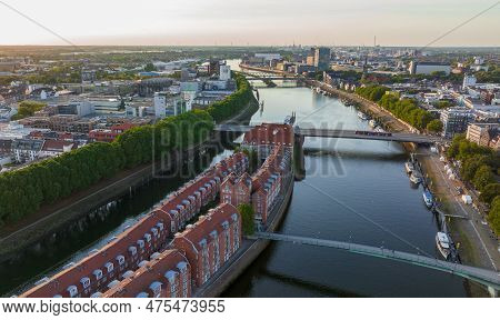 Bremen, Germany. Aerial View On A City Of Bremen, Drone Flight Above The River Weser At Sunset Time