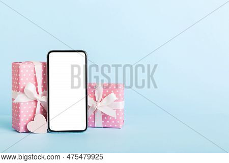 Mobile Phone With Blank Screen On Colored Background With Hearts, Calendar And Gift Box, Valentine D
