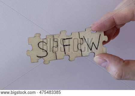 The Acronym Sfw, Which Stands For Safe For Work. The Letters Written On The Puzzles.