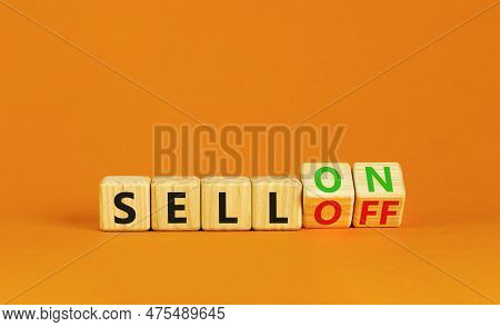 Sell On Or Off Symbol. Businessman Turns Wooden Cubes And Changes Word Sell Off To Sell On. Beautifu