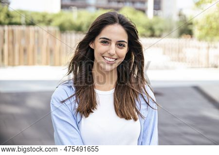 Portrait Of Beatiful Young Woman Smiling In The City. Happy Young Woman Smiling And Looking At Camer