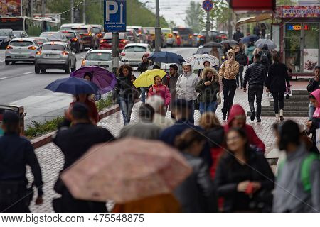 Bucharest, Romania. 27th Apr, 2023: People With Umbrellas Walk On The Street Despite The Rainy Weath