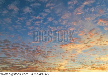 Many Small Clouds In The Evening Sky Illuminated By Sunlight At Sunset