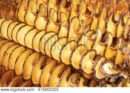 The Fried Potatoes Cut In The Form Of A Spiral On Skewers. Chips Potatoes. Organic Food. Street Food