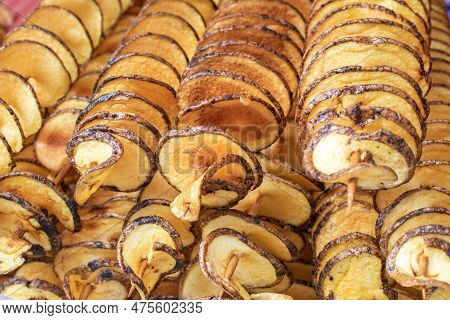The Fried Potatoes Cut In The Form Of A Spiral On Skewers. Chips Potatoes. Organic Food. Street Food