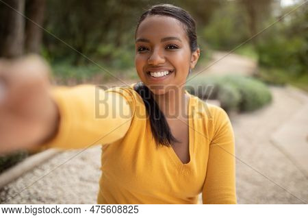 Cheerful Smiling Brazilian Lady Taking Selfie Outdoors In City Park, Happy Young Female Capturing Se