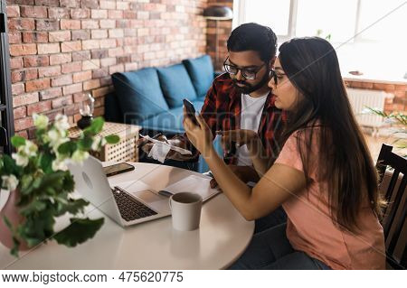 Serious Wife And Husband Planning Budget, Checking Finances, Focused Young Woman Using Online Calcul