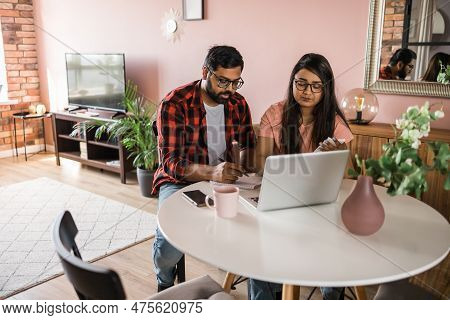 Serious Wife And Husband Planning Budget, Checking Finances, Focused Young Woman Using Online Calcul