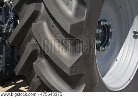 Tractor Tire Close Up.  Tractor Tire Mounted On White Wheel