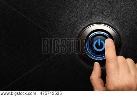 Finger About To Press A Power Button On Car Dashboard