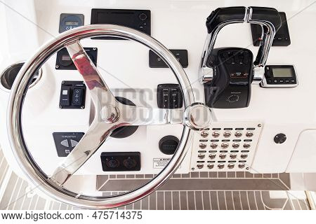 Luxury Yacht Control Panel With Steering Wheel, Gear Levers, Navigation Devices And Control Buttons.
