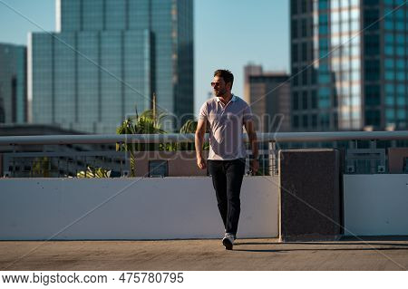 Young Handsome Man In Classik Polo T-shirt On The Street. Handsome Confident Stylish Hipster Model P