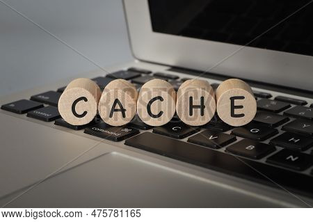 Wooden Cube Block On Computer Keyboard With Text Cache.