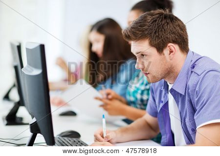 education concept - student with computer studying at school