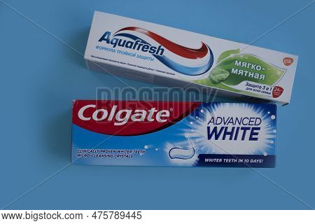 April 25, 2023 Ukraine City Kyiv Toothpaste Colgate And Aquafresh On A Colored Background