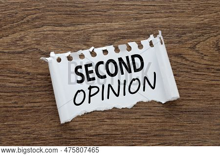 Torn Paper From A Notebook With The Text Second Opinion On The Table