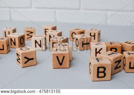 Wooden Cubes With Black Letters On A Gray Table, Close Up. Cubes Made Of Eco-friendly Material. Fron