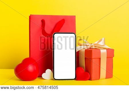 Mobile Phone With Blank Screen On Colored Background With Hearts, Calendar And Gift Box, Valentine D