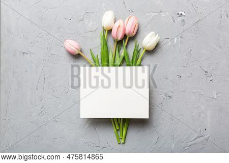 Composition With Blank Card And Beautiful Flowers Tulip On Coloredbackground. Top View With Space Fo