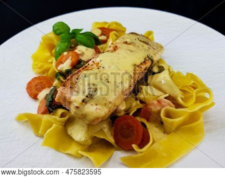 Italian Pappadelle Pasta With A Roasted Salmon Steak And Vegetables