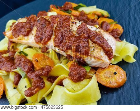 Italian Pappadelle Pasta With A Roasted Salmon Steak And Vegetables