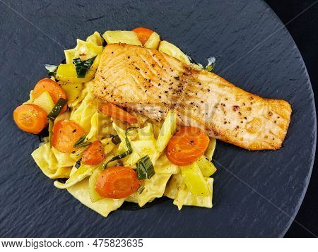 Italian Pappadelle Pasta With A Roasted Salmon Steak And Vegetables