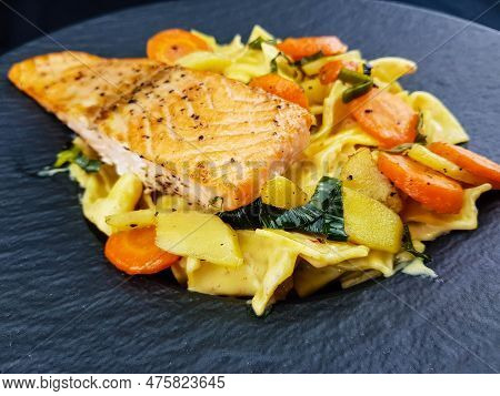 Italian Pappadelle Pasta With A Roasted Salmon Steak And Vegetables